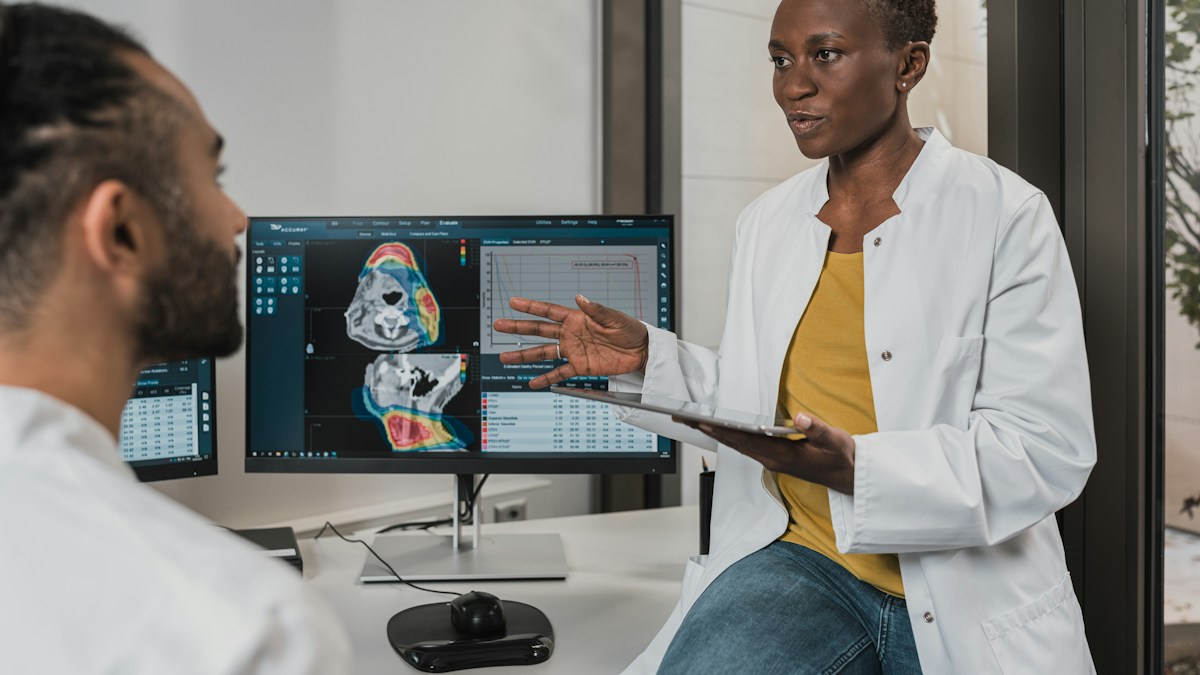 Médico utilizando tablet e sistema digital para acompanhamento em tempo real da grade de atendimentos e prontuário